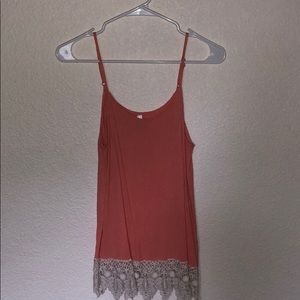 Orange tank top with while lace bottom detail
